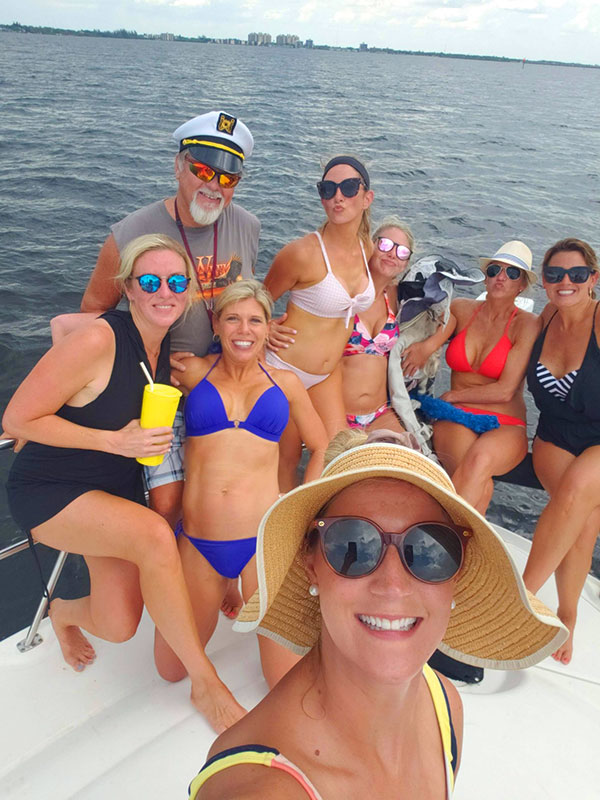 Guests posing off shore of Fort Myers Beach on the Carolina Daze